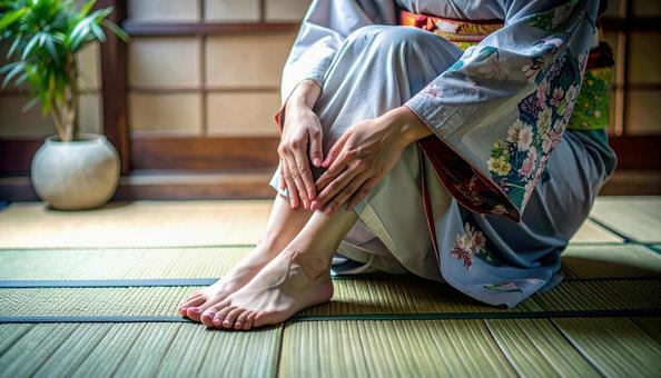 正座のあと、痺れた足をさする女性 正座のあと、痺れた足をさする女性の写真