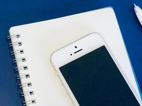 白いリングノートとスマホ(ネイビー背景) 白いリングノートとスマホ(ネイビー背景) スマホ,ノート,仕事の写真素材