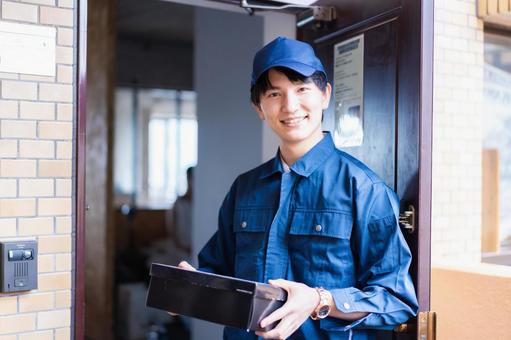 Male delivery man delivering a box, JPG