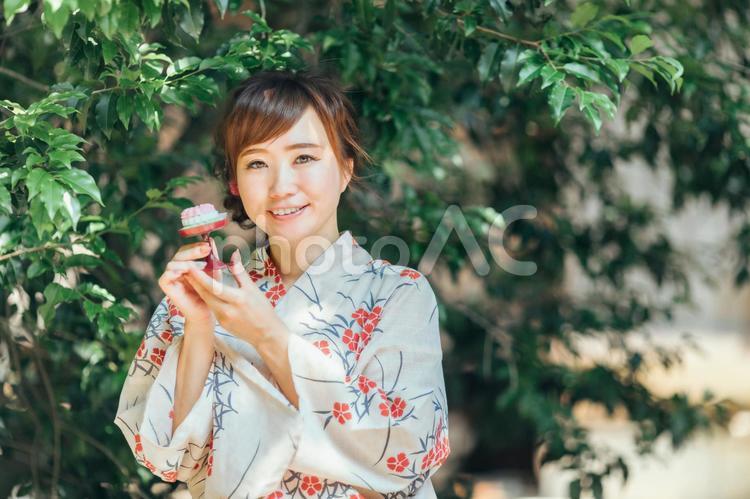 お供物を持つ浴衣姿の女性 お盆,盆菓子,浴衣の写真素材