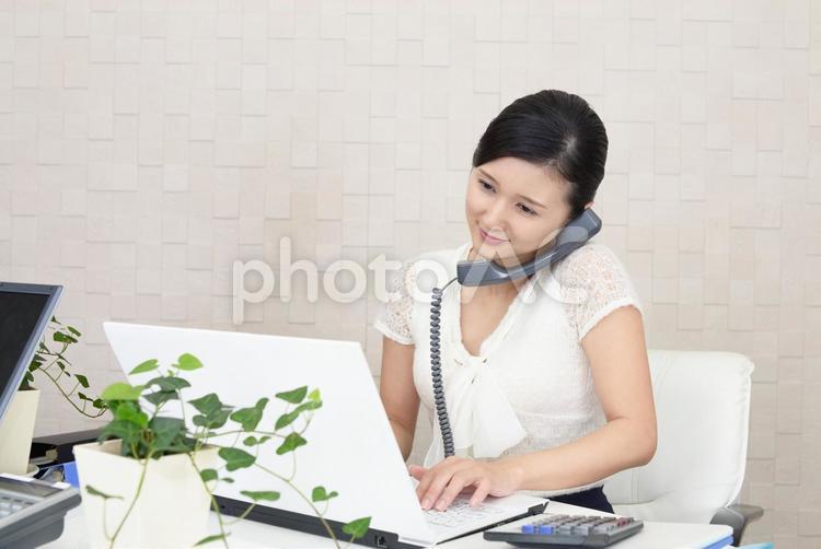 オフィスで電話応対をする女性 女性,ビジネスウーマン,ビジネスの写真素材
