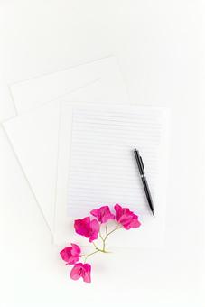Pink flowers and a page of a notebook with white paper and a ballpoint pen, mock up, monument shooting, paper, JPG