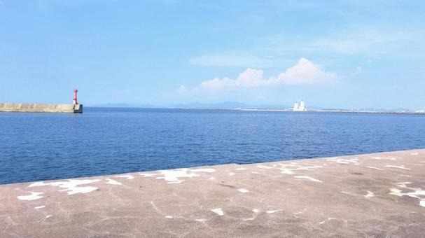 Red lighthouse on the breakwater and calm sea, JPG Red lighthouse on the breakwater and calm sea, JPG