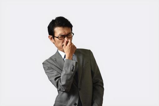 鼻をつまむビジネスマン 臭う,生乾き,加齢臭の写真素材
