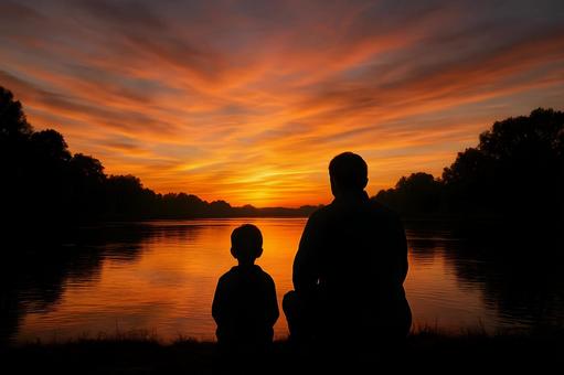 湖畔で語らう親子の写真