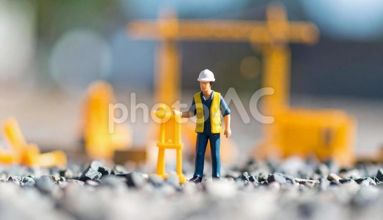 建設現場で働く建設作業員のフィギュア人形 建設現場,安全服,クレーンの写真素材