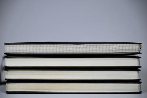 Stack of black-covered notebooks, JPG