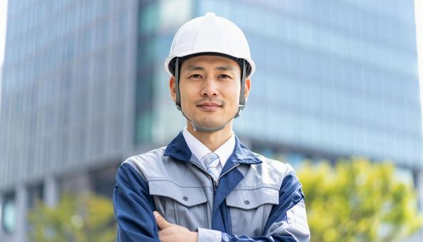 A man in work clothes with his arms crossed in front of a skyscraper, people, work clothes, male, JPG