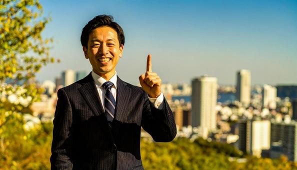 都市背景で人差し指を立てるビジネスマン 都市背景で人差し指を立てるビジネスマンの写真