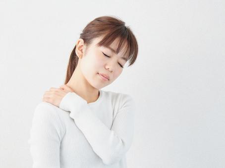 Image of a woman with stiff shoulders Image of a woman with stiff shoulders