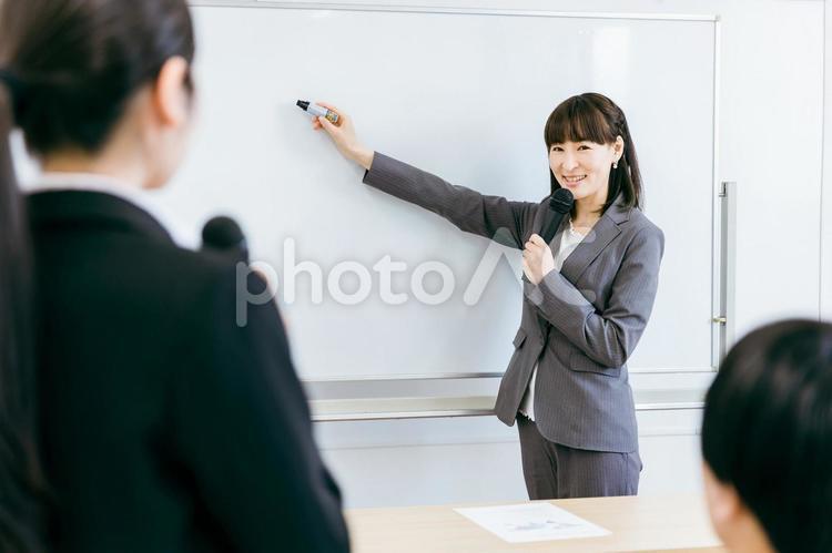 プレゼンをする女性講師と質問する女性 プレゼン,講師,セミナーの写真素材