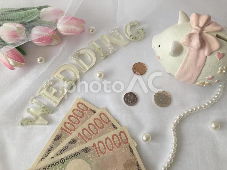 WEDDINGの文字とお金と貯金箱と花 wedding,結婚式,結婚の写真素材