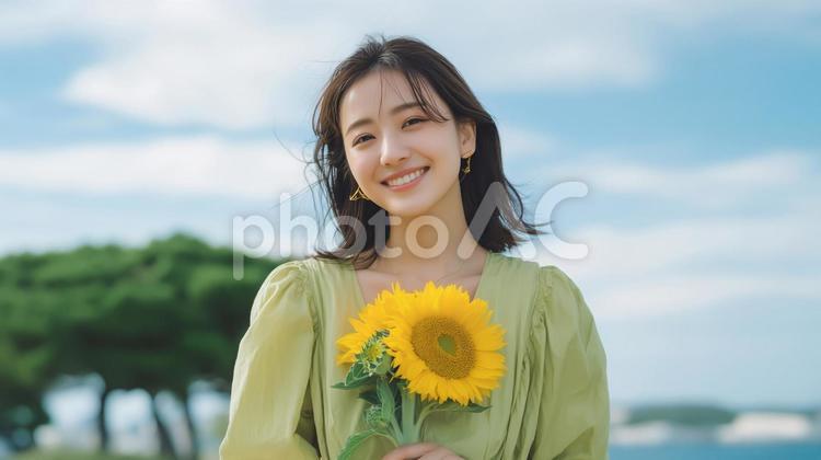 ひまわりと緑色のワンピースを着た女性 ひまわり,ヒマワリ,ワンピースの写真素材