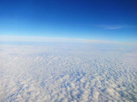 Photo, above the clouds, view from airplane, blue sky, 