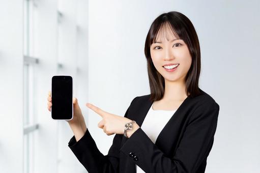スマホを持つ笑顔の女性・ビジネスウーマン 女性,スマホ,笑顔の写真素材