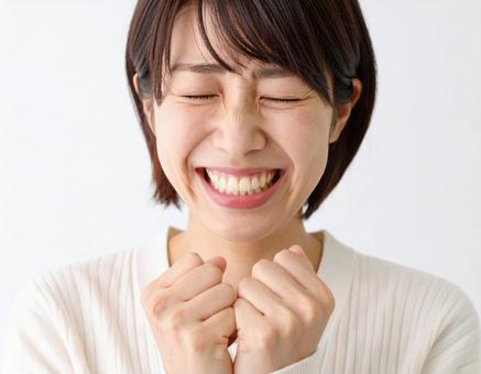 感激して拳を握る女性 感激して拳を握る女性の写真