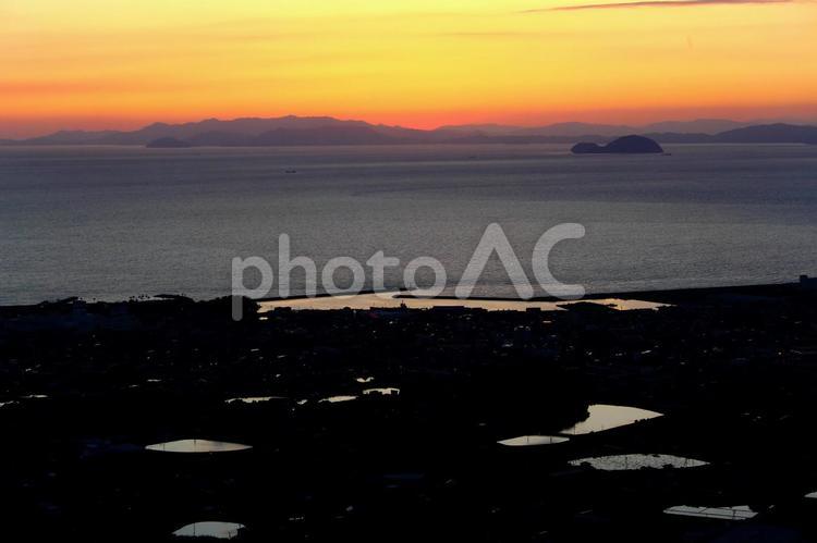 伊予市の夕日と溜池 伊予市,夕焼け,由利島の写真素材