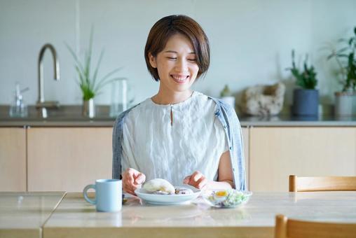 部屋で朝食を食べる女性 部屋で朝食を食べる女性 食事,女性,朝食の写真素材