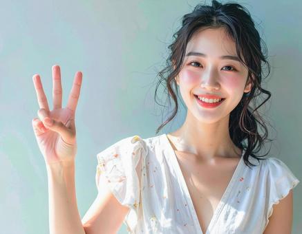 3を指で示す笑顔の女性 3を指で示す笑顔の女性の写真