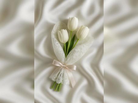 やわらかな布の上の白いチューリップの花束 やわらかな布の上の白いチューリップの花束の写真