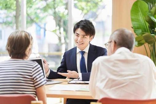 A businessman who advises an elderly couple on buying and selling real estate A businessman who advises an elderly couple on buying and selling real estate