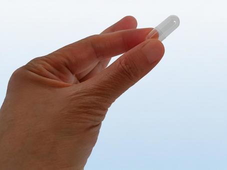 カプセルを手で持つ 薬,カプセル,カプセル錠の写真素材