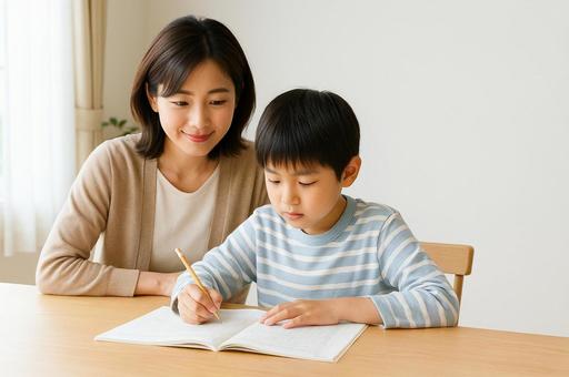 試験に向けて問題集に取り組む小学生 試験に向けて問題集に取り組む小学生の写真