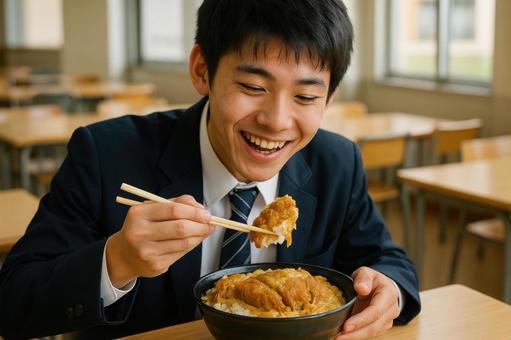 かつ丼大盛りを食べる男子高校生 かつ丼大盛りを食べる男子高校生の写真