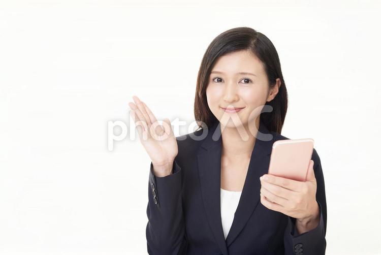 スマートフォンを持つ笑顔のビジネスウーマン 女性,ビジネスウーマン,女の写真素材