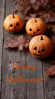 木の板に並ぶハロウィンかぼちゃと秋の葉の写真