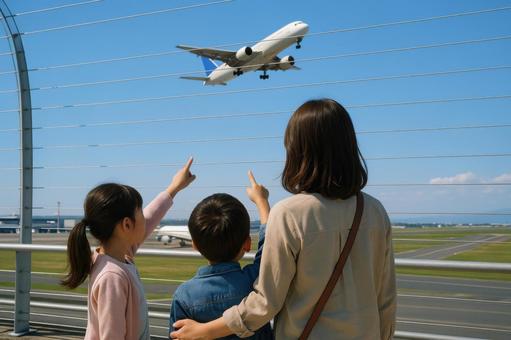 空港の展望デッキで飛行機を見上げる親子の写真