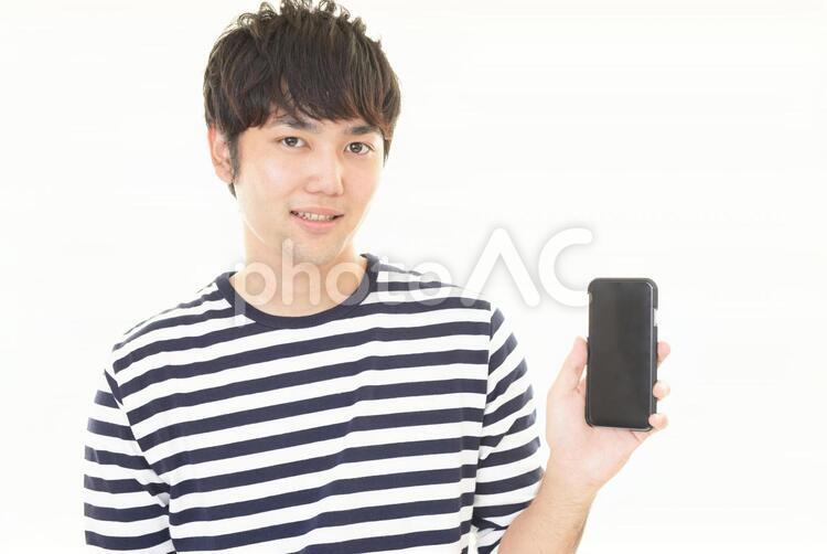 スマートフォンを持つ笑顔の男性 男性,男,スマートフォンの写真素材
