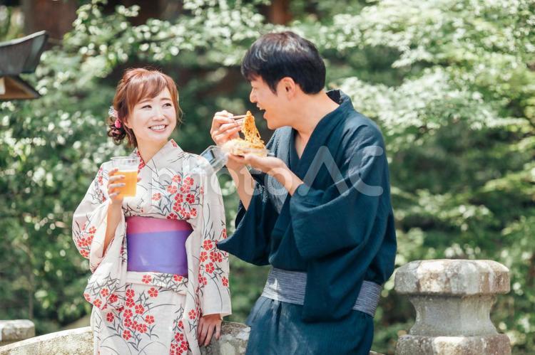 夏祭りにきてビールや焼きそばを食べる男女 夏祭り,縁日,たこ焼きの写真素材
