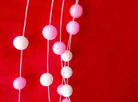 紅の背景に咲き誇る　新年の彩り 餅花,まゆ玉,お正月飾りの写真素材