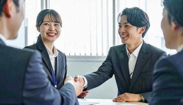 握手するビジネスパーソン 握手するビジネスパーソンの写真