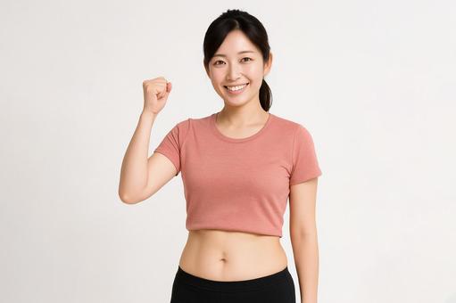 笑顔でガッツポーズをする若い女性02 笑顔でガッツポーズをする若い女性02の写真