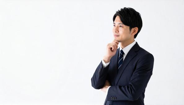 悩み考えるビジネスマン 悩み考えるビジネスマンの写真