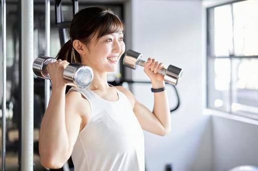 Asian female doing shoulder press in training gym, training gym, female, japanese, JPG