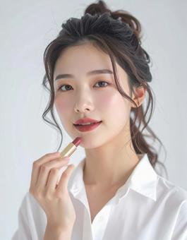 リップを塗る若い女性の美容ポートレート リップを塗る若い女性の美容ポートレートの写真