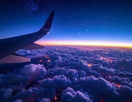 旅客機の窓から見える雲海と主翼と月の写真