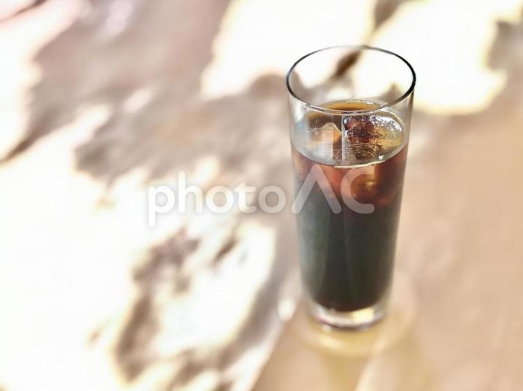 木漏れ日のテーブルにアイスコーヒー アイスコーヒー,木漏れ日,陽射しの写真素材