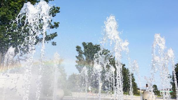 A fountain with a rainbow color in the spray, JPG A fountain with a rainbow color in the spray, JPG