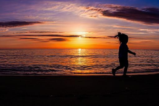 Children running on the beach at sunset, JPG
