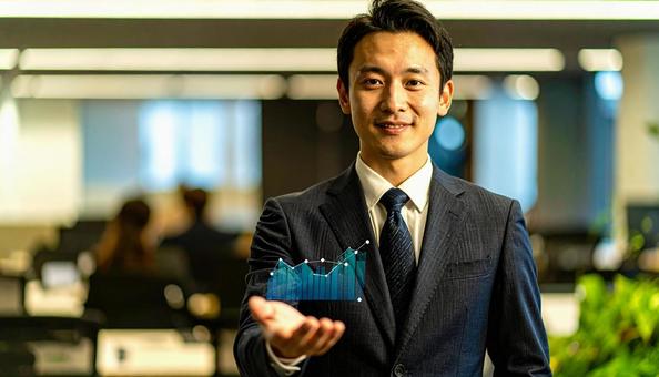 右上がりのグラフを片手に持つビジネスマン 右上がりのグラフを片手に持つビジネスマンの写真
