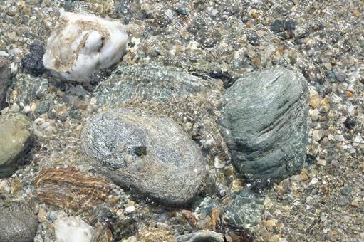 A stone in the water found on the beach, JPG