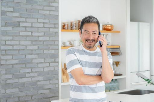 キッチンでスマホを使うミドルの男性 キッチンでスマホを使うミドルの男性 男性,スマホ,ミドルの写真素材