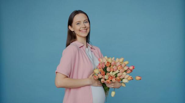チューリップを持って振り向く女性 チューリップを持って振り向く女性 女性,人物,重ね着の写真素材