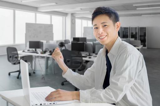 ガッツポーズする私服男性 男性,若者,大学生の写真素材