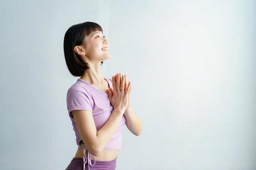 A woman doing yoga (gassho) poses, female, yoga, indoor, JPG