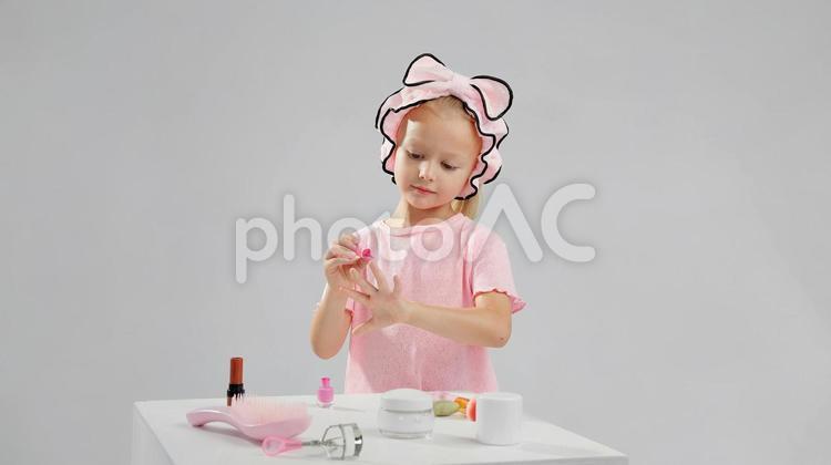 真剣な顔で爪を塗る女の子 女の子,ネイル,マニキュアの写真素材